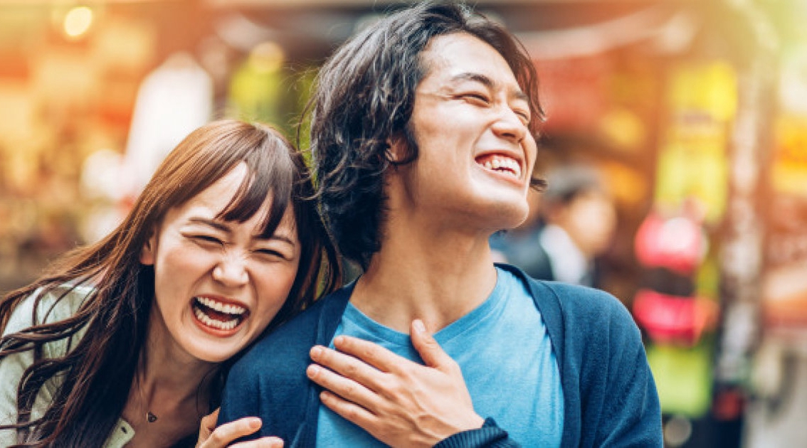 Young Japanese couple smiling outdoors. Shot made during iStockalypse Tokyo 2015.