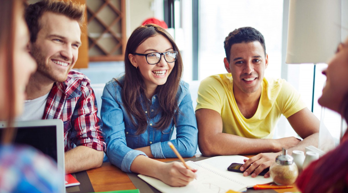 Happy teens spending leisure in cafe